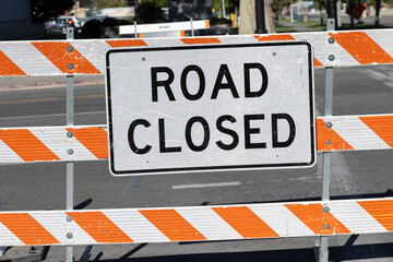 Photograph of road closed signage sitting on urban street