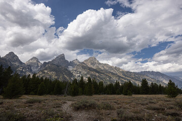Fototapeta premium Beautiful scenic cloudy day and the Grand Teton Mountains on the horizon. Location The Grand Tetons National Park in Wyoming
