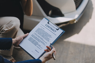 A young businesswoman is navigating car insurance options at her desk, considering premiums, deductibles, and coverage while understanding policies and managing claims efficiently.