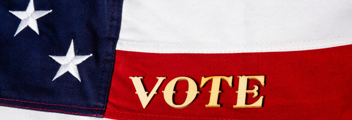 The word vote resting on the USA flag