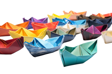 A collection of different paper boats of various colors and designs, arranged artistically on a white background