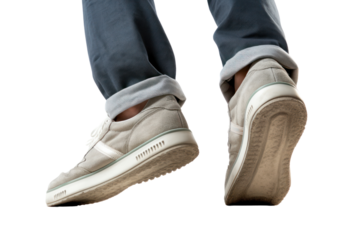 A close-up view of a persons feet in athletic shoes climbing a set of concrete stairs, , isolated on white background