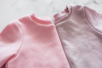 new vs old and used clothes, identical sweaters, side by side, unused vs worn out discoloured and...