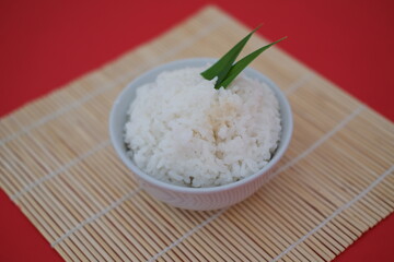 Cooked rice in a bowl with red background
