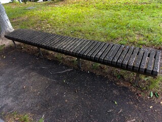 A wooden bench sitting in the middle of a park