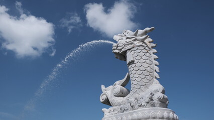 Fototapeta premium Famous Dragon Carp fountain soars into blue sky in Da Nang, Vietnam