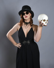 
Close up portrait of beautiful  female model wearing black dress and steampunk spectacles and top...