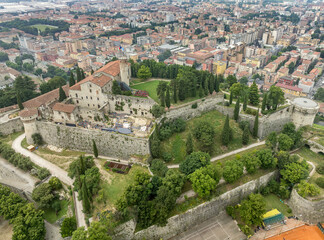 Aerial view of Brescia medieval castle, city center, city walls, bastions, vineyards in Lombardy...