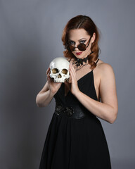
Close up portrait of beautiful  female model wearing black dress and steampunk spectacles and top...
