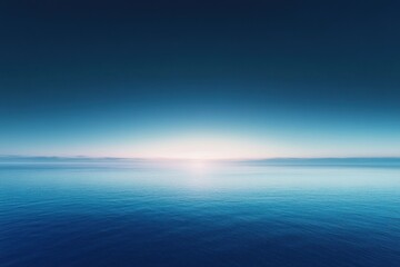 Obraz premium A Calm, Expansive Ocean at Dawn with a Subtle Glow in the Distance