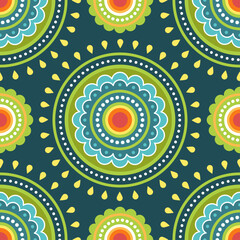 Seamless pattern. Green, blue and yellow symmetrical round ethnic mandala on darl green background. Oriental pattern. Indian or Arabic mandala. Diwali festival. Fabric, wrapping paper.
