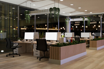 The interior design of a contemporary office in a skyscraper at night features computer desks. © bongkarn