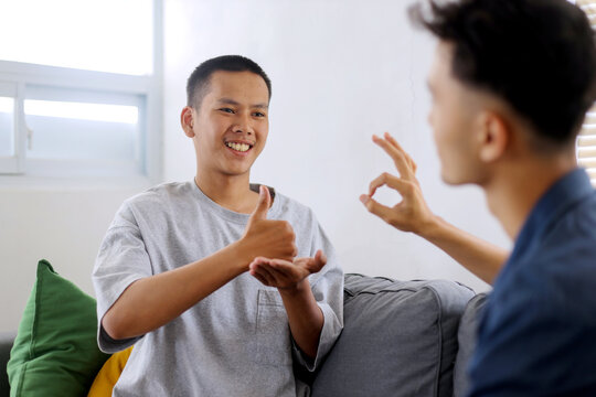Young Asian Man Signs With her Therapist, Showing Empathy and Connection. Sign language concept
