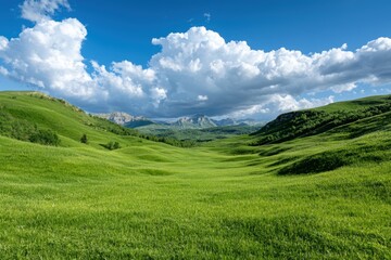 Naklejka premium Scenic mountain landscape with green rolling hills and dramatic cloudy sky