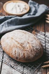 Naklejka premium Freshly baked loaf of homemade bread on the grill
