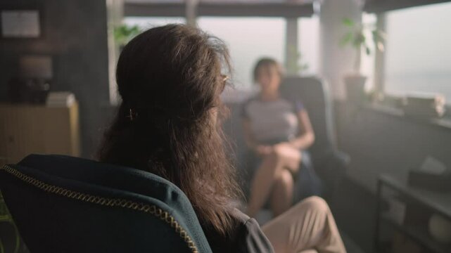 Close up of female psychotherapist talking with teenager with mental illness, providing psychotherapy or treatment. African American teen girl during therapy session. Psychological help and advice.