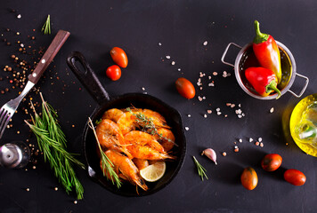 Grilled shrimps with greens and garlic in a pan