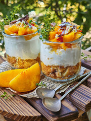 Dessert with peaches and yogurt on a wooden table