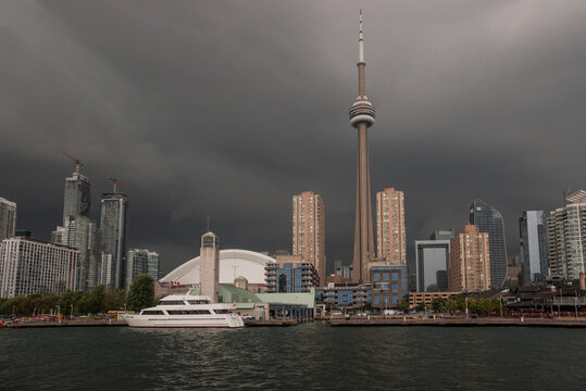 Before the storm - city skyline panorama, calm water and storm clouds approaching the city. Rough weather, dramatic sky, thunderstorm, dark clouds. Toronto, Ontario, Canada