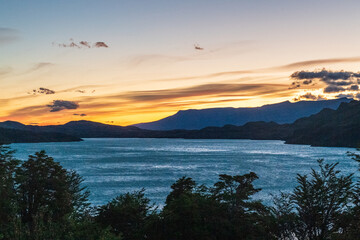 Night fall along an impressive mountain landscape in Torres Del Paine national park, along lake Nordenkjold, in Patagonia, Chile.