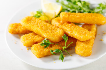 fish fingers sticks with salad and lemon