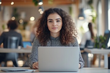 Stylish Middle Eastern Manager working in creative office with colleagues.