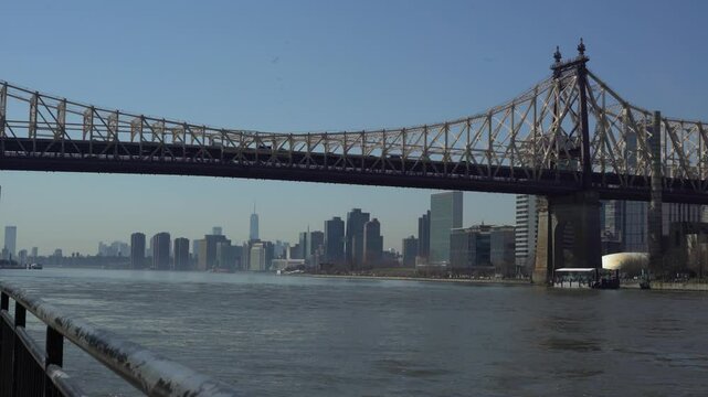 Wide shot of Queensboro bridge walkway with Freedom Tower in the distance