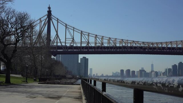 Wide shot of Queensboro bridge walkway with Freedom Tower in the distance