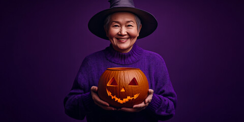 Fototapeta premium Joyful Non-Binary Senior Holding Cauldron in Halloween Setting 