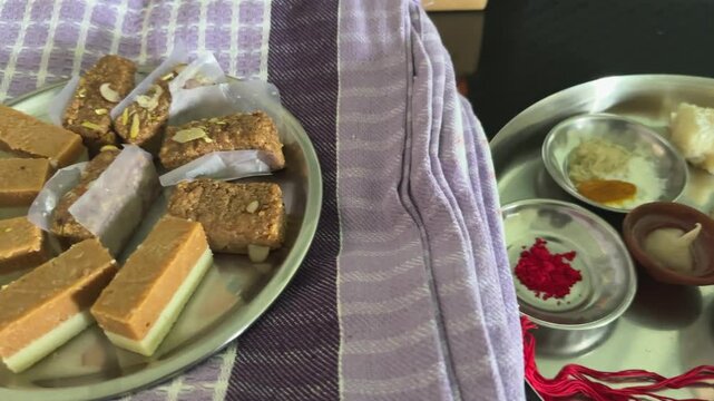 Dolly shot going left to right of Indian Sweets and Rakhi thaali showing prepration for Rakhi The indian traditional festival of brother and sister