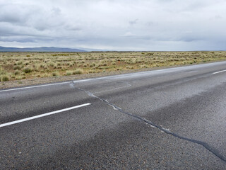 Asphalt road in the steppe on a cloudy day