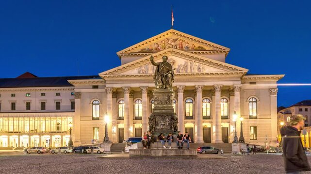 Munich National Theatre or Nationaltheater on the Max Joseph square night timelapse hyperlapse. Illuminated historic opera house front view, home of the Bavarian State Opera. Germany