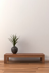 A minimalist wooden bench with a potted plant against a plain wall in a serene indoor setting