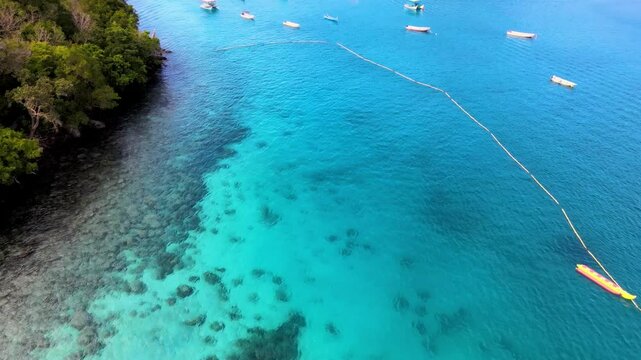 Boat Sailing by Pier with Emerald Sea and Coastal Views