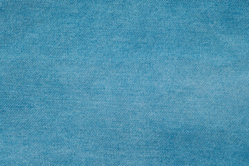 Textured blue denim fabric background showcasing a smooth and even weave pattern