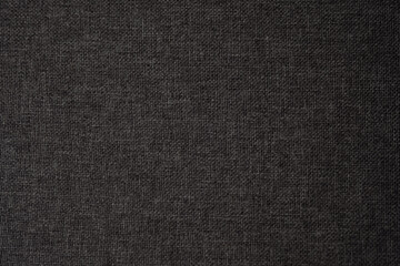 Detailed close-up of textured dark fabric showcasing its weave and depth in natural light