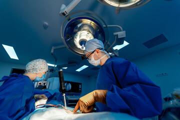 Surgeons in a modern heart surgery room. A team of surgeons conducts a delicate heart surgery in a well-equipped operating room during a busy surgical session.