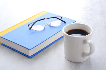淹れたてのコーヒーを飲みながら、のんびり読書を楽しんでいるイメージ
