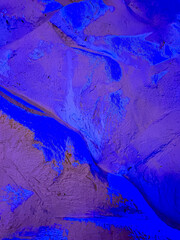 Naklejka premium Textured blue landscape patterns. Textured surface illuminated in vibrant blue, showcasing intricate patterns akin to abstract topography or natural formations.