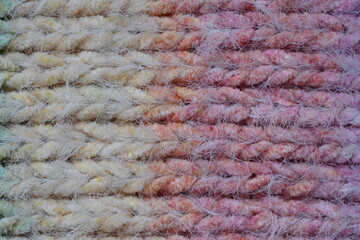 Macro texture of acrylic multicolored rainbow pastel crocheted winter clothing sweater as background, close-up of rainbow front surface, multicolored wool texture, crocheted front surface, part of sca