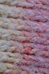 Macro texture of acrylic multicolored rainbow pastel crocheted winter clothing sweater as background, close-up of rainbow front surface, multicolored wool texture, crocheted front surface, part of sca