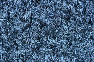  close-up of gray crocheted front surface, woolen texture of woolen wool, knitted front surface, macro texture of woolen dark gray crocheted sweater as background