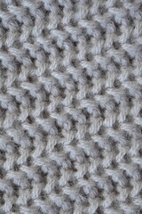 macro texture of woolen pastel crocheted sweater as background, close-up of brown crocheted front surface, woolen texture of woolen wool, trend pastel crocheted front surface