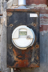 The full of the digital electric meter on the old metal cabinet hanging on the wall which closed in...