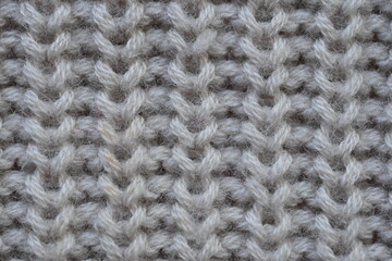 macro texture of woolen pastel crocheted sweater as background, close-up of brown crocheted front surface, woolen texture of woolen wool, trend pastel crocheted front surface