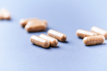 Carnitine capsules. Concept for a healthy dietary supplementation. Bright paper background. Soft focus. Close up.	