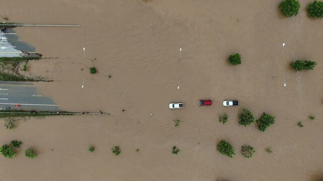 Aerial view of cars driving on road flooded during typhoon Yagi has swept Southeast Asia.