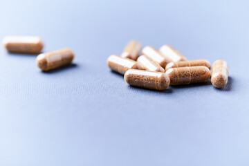 Carnitine capsules. Concept for a healthy dietary supplementation. Bright paper background. Soft focus. Close up.	
