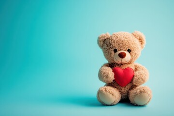 Obraz premium A cheerful teddy bear with a small heart sitting against a soft blue background, perfect for conveying love and comfort in any setting