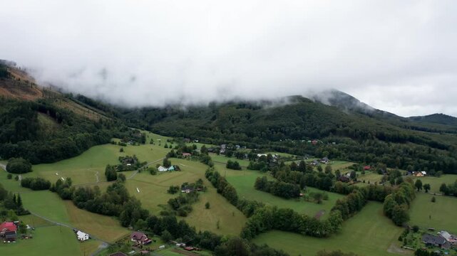 Drone shot of misty and cloudy mountains